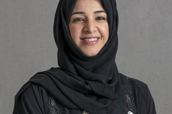 Her Excellency Reem Al Hashimy, a distinguished leader and visionary, stands confidently against a backdrop of the UAE flag. With a remarkable journey in diplomacy, international cooperation, and philanthropy, she has played a pivotal role in shaping the nation's global presence. Her commitment to education, strategic leadership, and fostering international relations is evident in her poised demeanor.