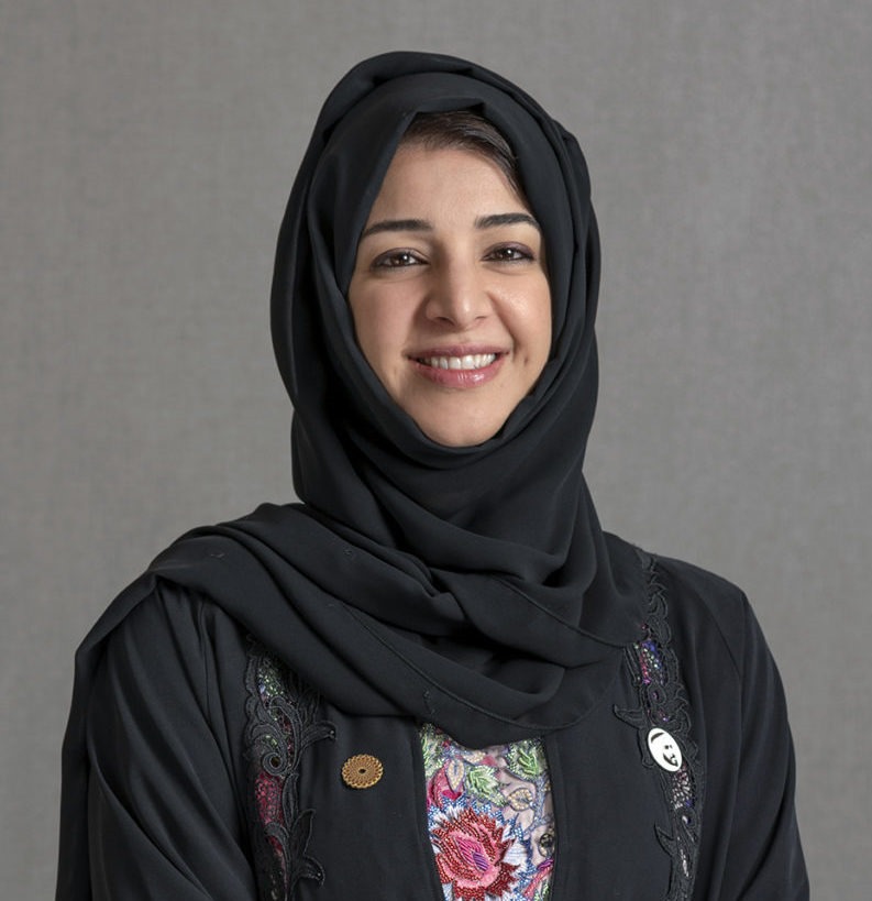 Her Excellency Reem Al Hashimy, a distinguished leader and visionary, stands confidently against a backdrop of the UAE flag. With a remarkable journey in diplomacy, international cooperation, and philanthropy, she has played a pivotal role in shaping the nation's global presence. Her commitment to education, strategic leadership, and fostering international relations is evident in her poised demeanor.