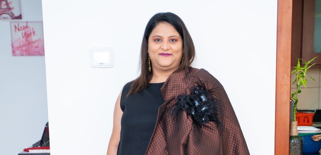 Anul Mundra, the founder of XpatzHub, exudes confidence and leadership in a vibrant and modern Dubai business setting. The image captures her as a dynamic entrepreneur and leader. Surrounding her are logos representing various media outlets and awards she has received, showcasing her influence in the business and social entrepreneurship space. The XpatzHub logo is prominently displayed, symbolizing the company's role as a hub for marketing and event solutions. The image embodies Anul Mundra's remarkable journey and the innovative approach of XpatzHub in Dubai's business and event management landscape.