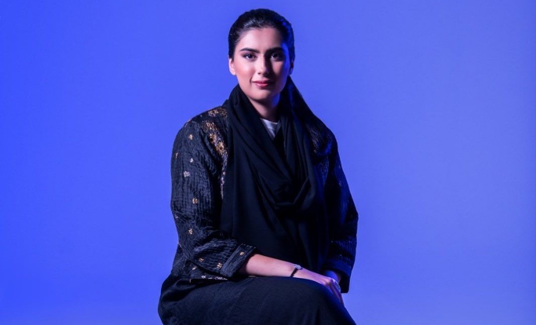 A portrait of Amira Hussain Sajwani, a pioneering entrepreneur in the real estate and education sectors. She is seen as a confident and accomplished businesswoman.