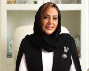A professional portrait of HH AlSayyida Dr. Basma Al Said, a distinguished Mental Health Clinical Expert and International Speaker. She exudes confidence and warmth, symbolizing her passion for mental health advocacy. In the background, there are symbols of mental well-being and global outreach, highlighting her commitment to making a positive impact on a global scale.