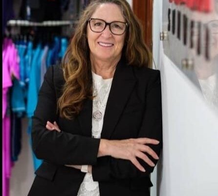 Maureen Hall, founder and CEO of COÉGA Sunwear, a top-tier swimwear brand in the UAE, reflects on her journey of determination, innovation, and commitment to inclusivity. The image showcases Maureen Hall and various COÉGA Sunwear products, embodying the brand's dedication to sustainable and inclusive swimwear, as well as its philanthropic initiatives.